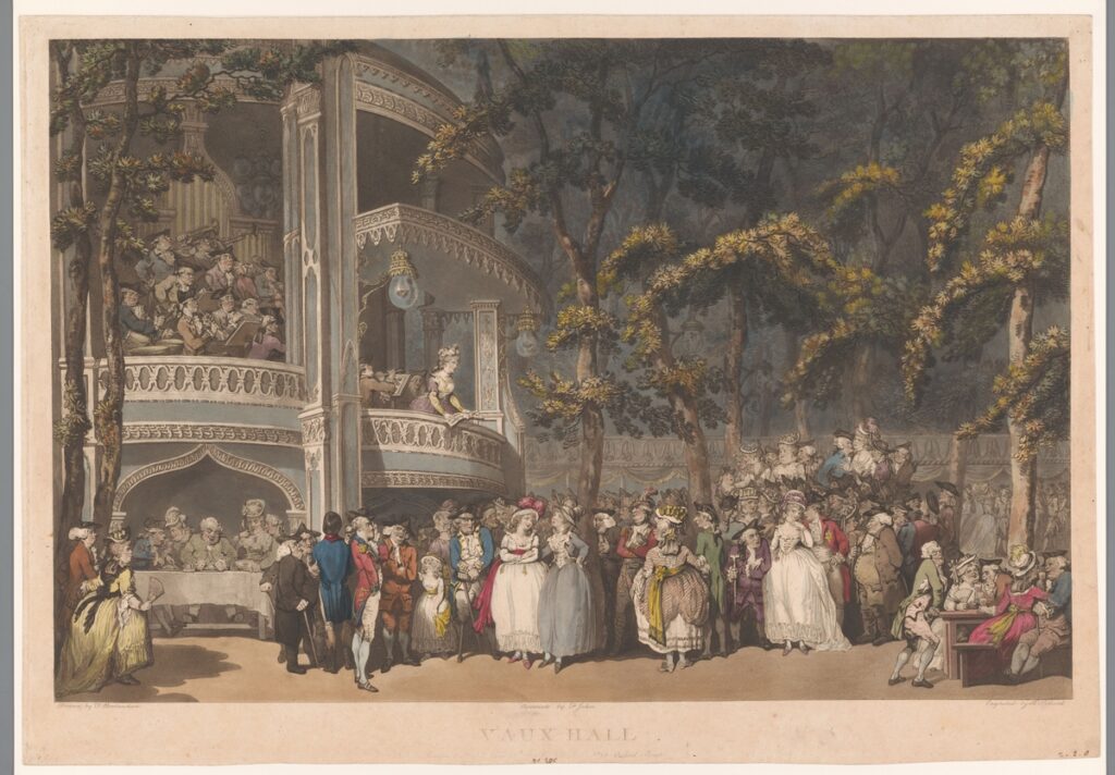 A crowd dining at tables in Vauxhall Pleasure Gardens, with members of the aristocracy seated on a balcony above. An early example of public dining in Britain, often considered a precursor to the first restaurants.