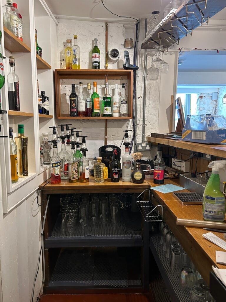 Cluttered shelves behind the bar in a restaurant 