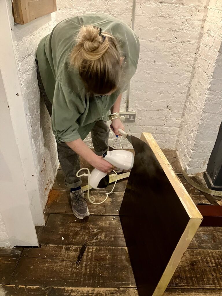 A lady up-cycles old cafe tables 